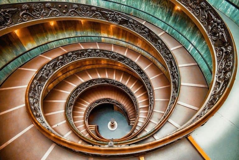 Bramante staircase at the Vatican in hues of orange and aqua.