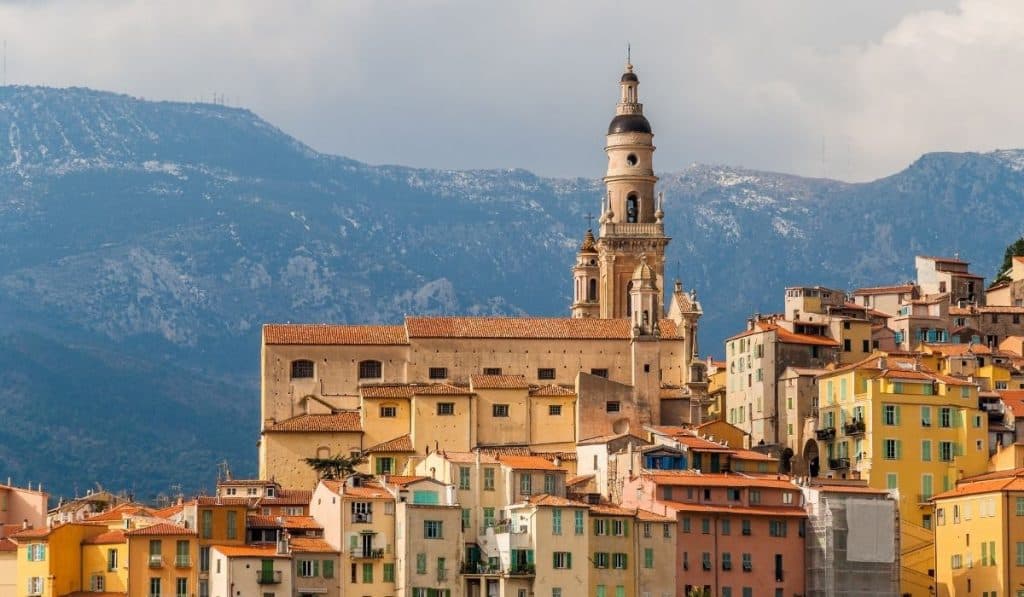 Saint-Michel Basilica in Menton with mountains in the background.